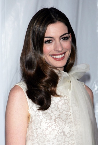 Actress Anne Hathaway models her classic feminine style, with her dark hair 