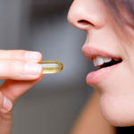 Woman taking anti-aging supplement