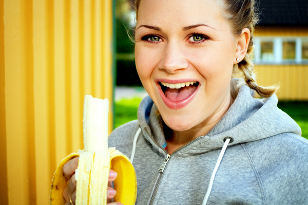 Woman eating banana