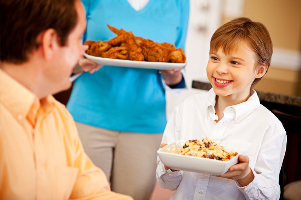 Boy helping serve dinner
