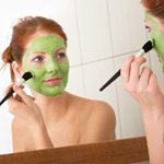 Woman applying homemade beauty mask treatment