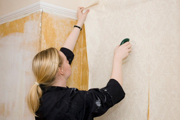woman applying wallpaper