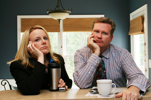 Unhappy couple drinking coffee.