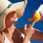 Woman putting on sunscreen