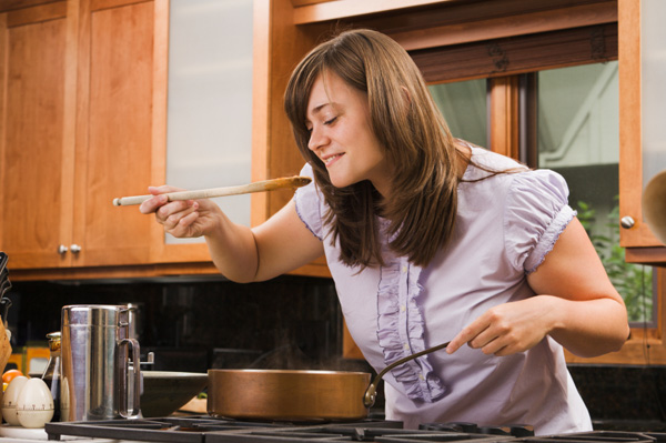 Woman cooking with skillet