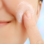 Woman exfoliating her skin