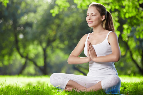 Woman meditating outdoors