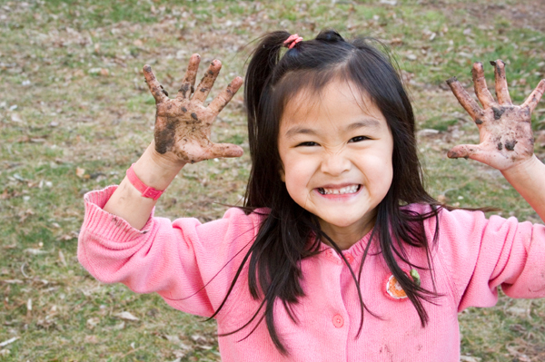 Girl with muddy hands