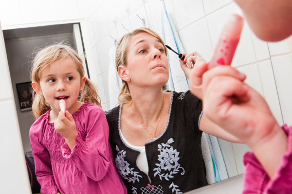 Mom applying makeup in the morning