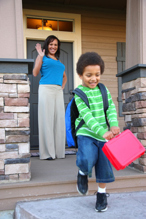 Mom sending son to school with lunchbox