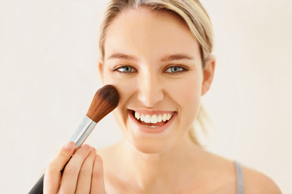 Woman applying blush