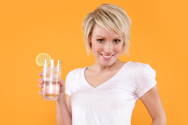 Woman drinking water with lemon