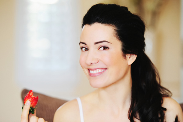 Woman eating strawberry