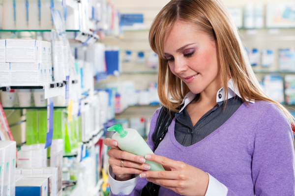 Woman reading lotion label