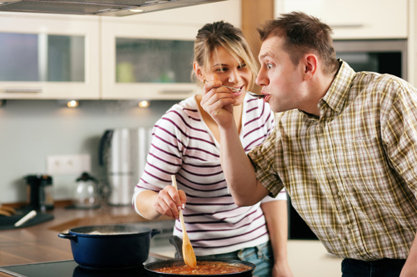 Husband tasting healthy meal