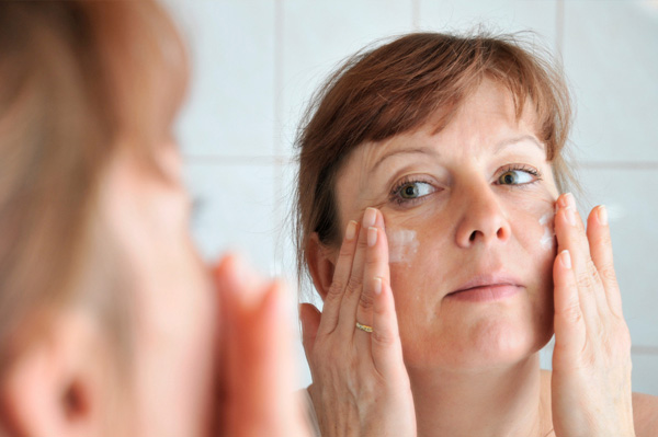 Woman applying face cream