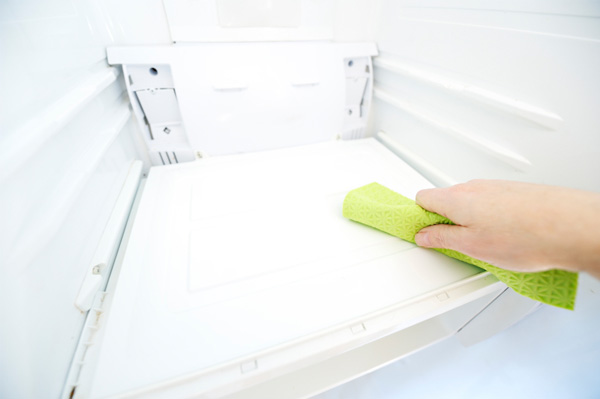Woman cleaning fridge