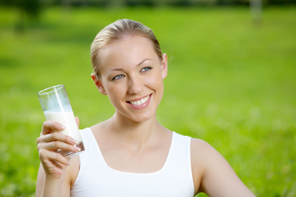Woman drinking milk outdoors
