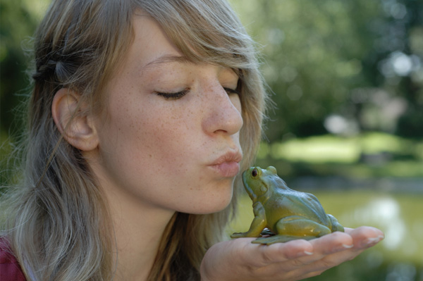 Woman kissing frog