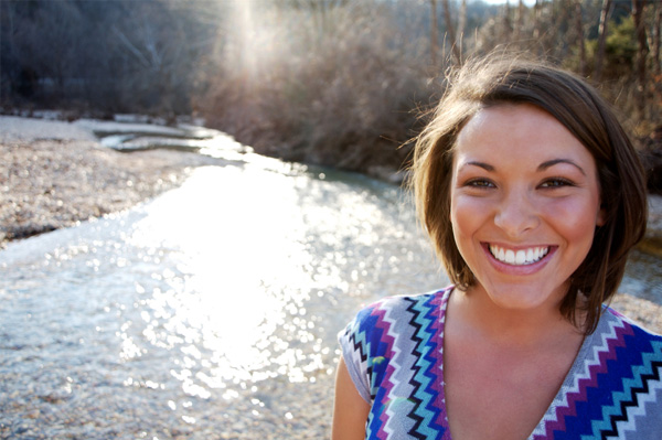 Happy woman in front of river