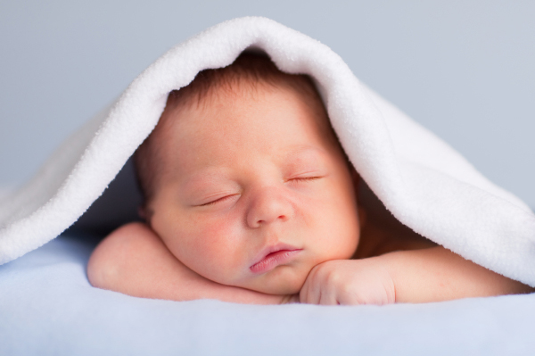 infant-boy-under-blanket