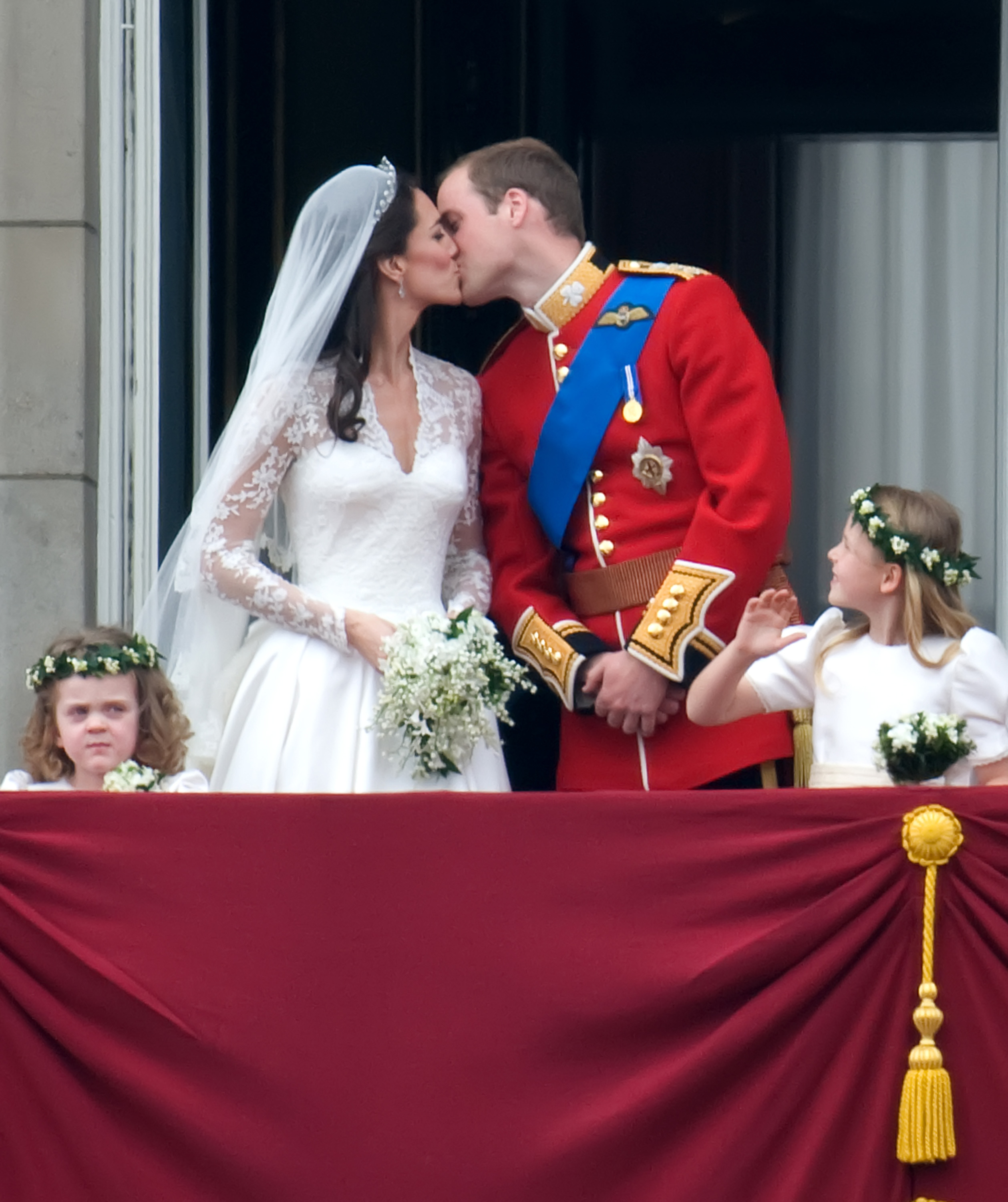 Kate Middleton in her wedding dress, kissing Prince William