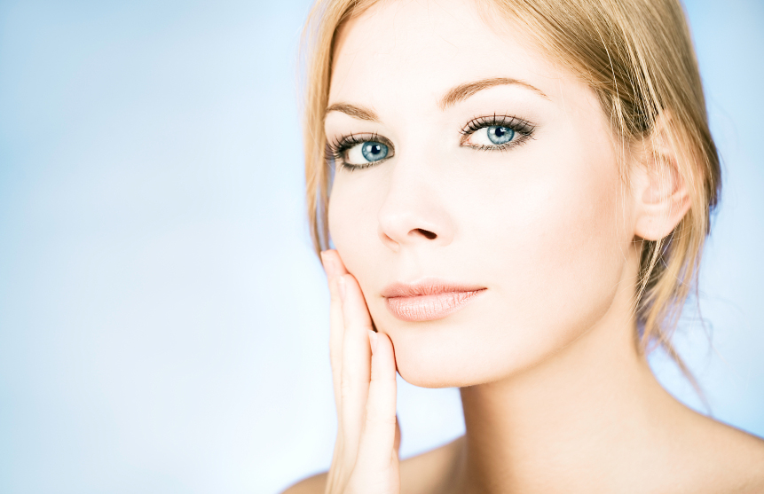 woman admiring her healthy, sensitive skin