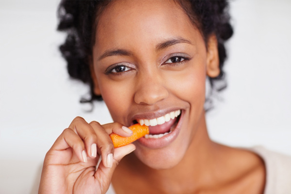 Woman snacking on carrot