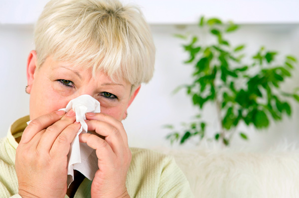 Woman with allergies at home