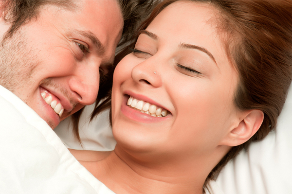 Couple smiling in bed
