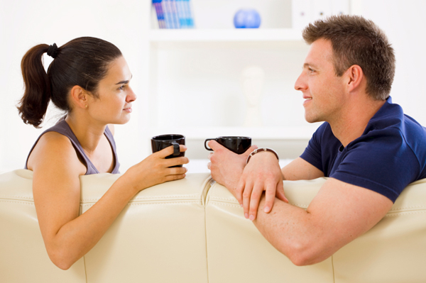 Couple talking on couch
