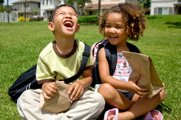 Happy kids with lunchboxes
