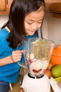 Little girl making smoothie