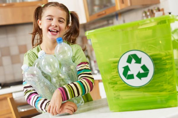 Little girl recycling in kitchen