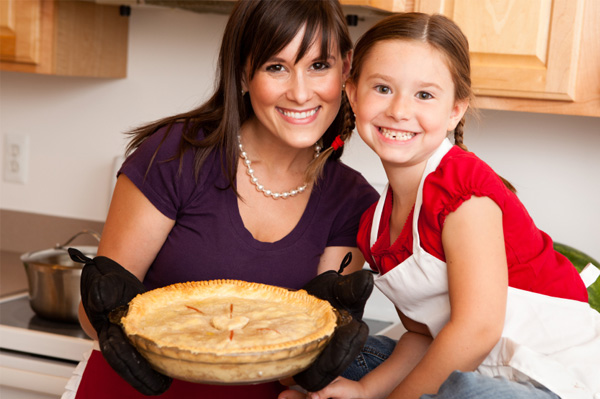 Mom and daughter making pie