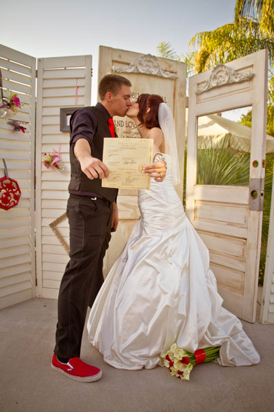 Bride kissing grom with red shoes