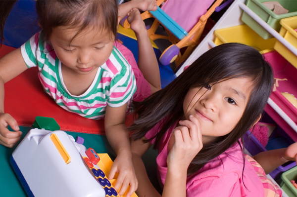 Girls playing with cash register