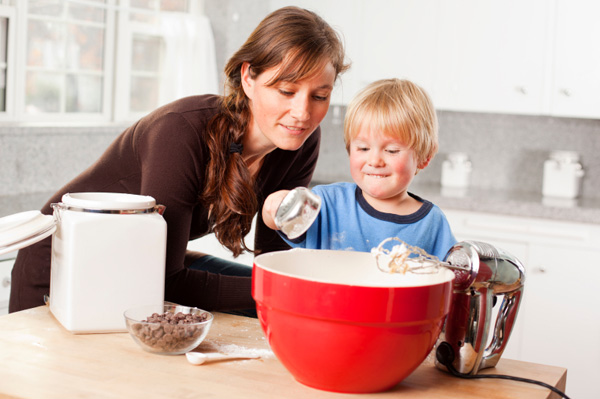 Little boy baking with mom