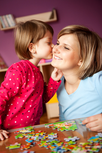 Mom doing puzzle with daughter