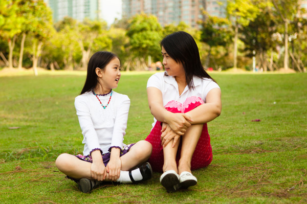 Mom talking to tween outside