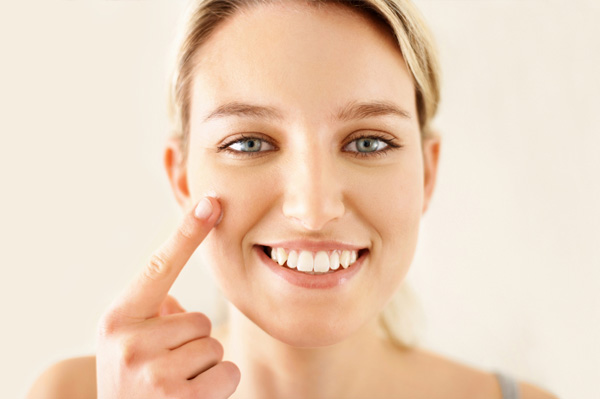 Woman applying tinted lotion