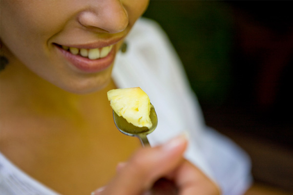 Woman eating pinneapple