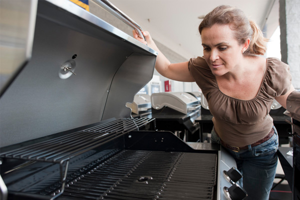 Woman shopping for grills