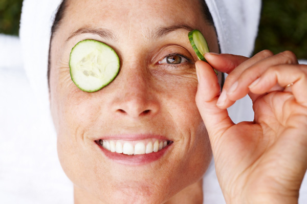 Woman with cucumbers on eyes