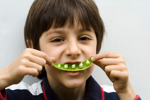 Boy with pea pod