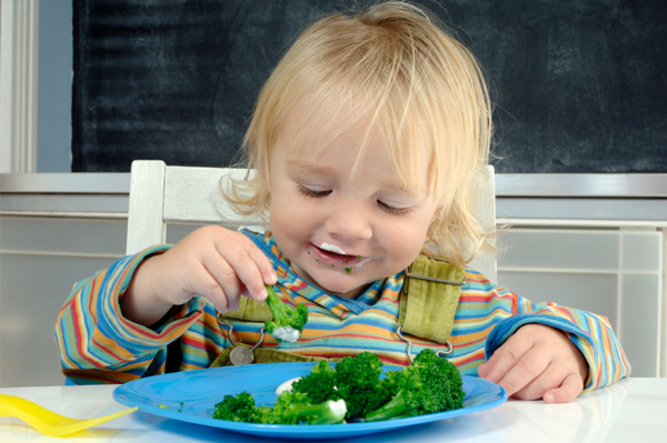 Child eating broccoli