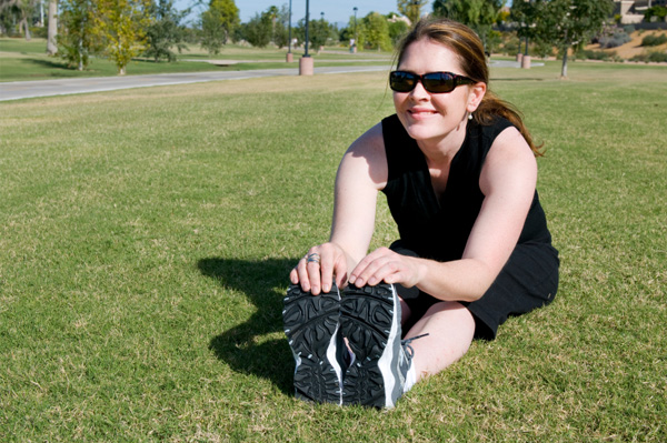 Confident woman stretching outdoors