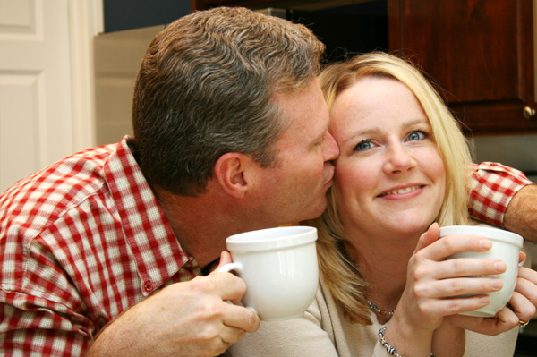 Couple kissing over coffee