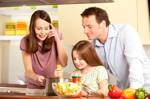 family cooking pasta