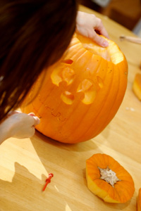 Girl carving pumpkin